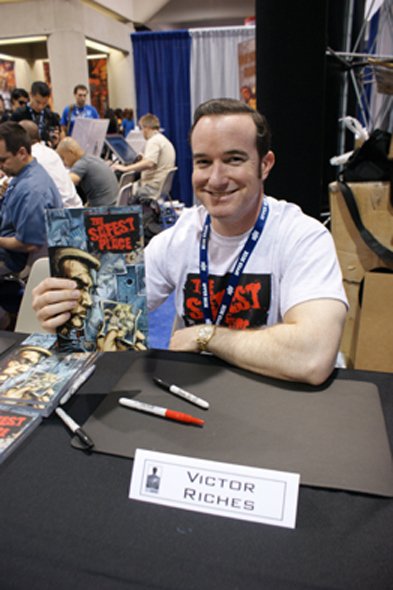 victor Riches signes comics at the San Diego Convention Center.