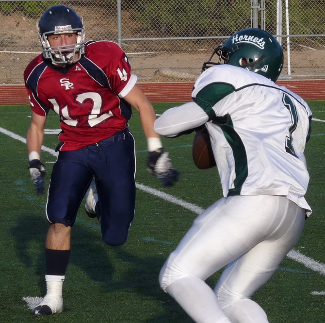 Lincoln quarterback Ronnie Yell gets ready to throw with Scripps Ranch defensive back Nick Brisichella closing in