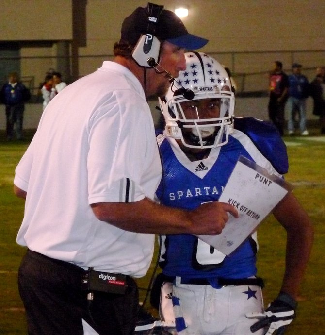 Chula Vista head coach Judd Rachow gives the play to receiver Darian Phillips