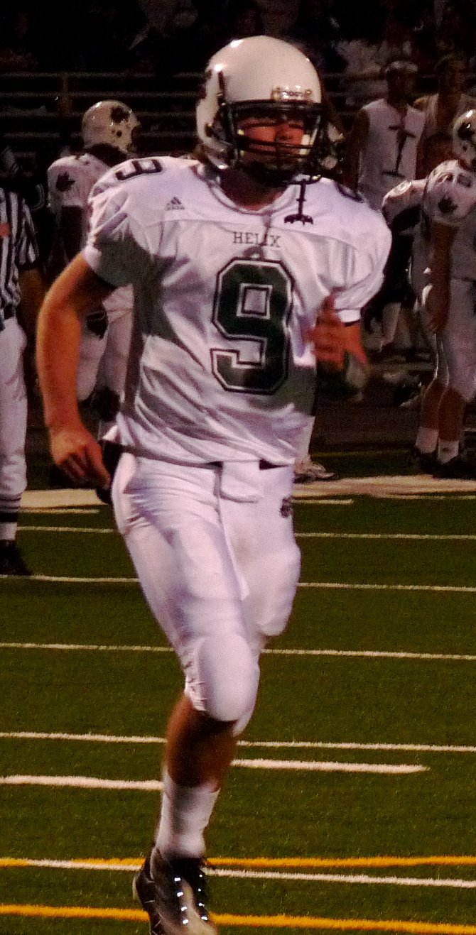Helix quarterback Ty Culver jogs back to the offensive huddle with the game in hand