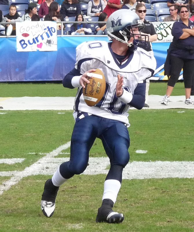Madison quarterback Taylor Patrick rolls out
