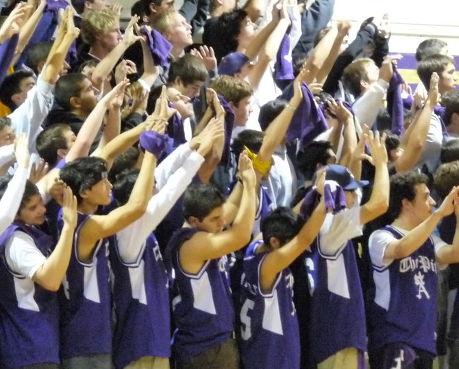 St. Augustine's student section holds up their hands during a Saints free throw