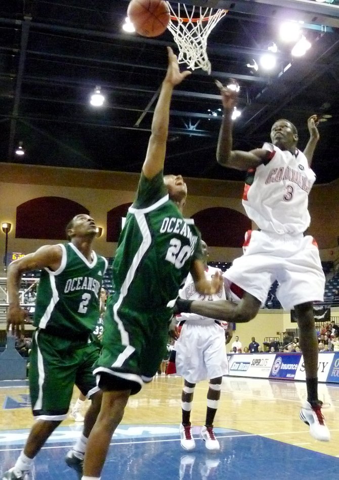 Oceanside forward Osmond Nicholas puts up a layup with Hoover center Angelo Chol defending