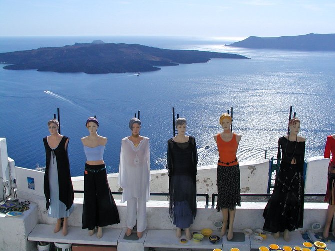 These girls are missing the spectacular view of the volcanic crater, the Caldera, Santorini, Greece.
