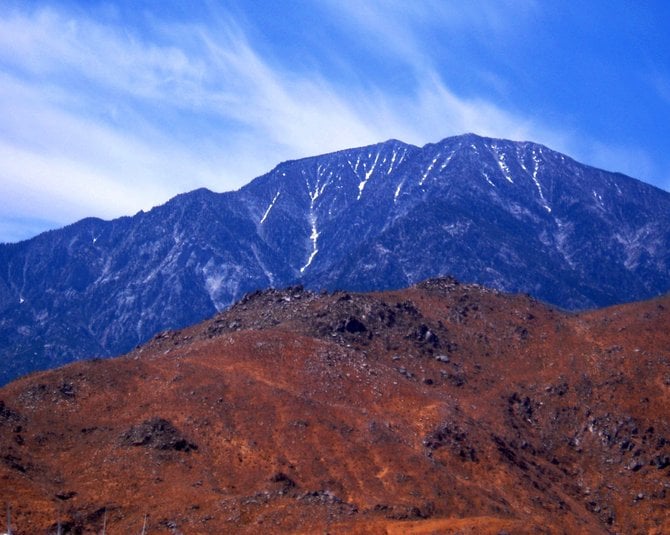 When I drive out to Palm Springs, there is a section on the 10 freeway at Cabazon, near the exit to Hadleys and the giant dinosaurs, where you get your first glimpse of the windmills, and you come upon this magnificent sight of Mt. San Jacinto. I've always been struck by the contrast of the desert hills below and the alpine mountaintop above. This is the point in the trip where I really start getting excited about a weekend full of hiking in both the desert and the snow.   