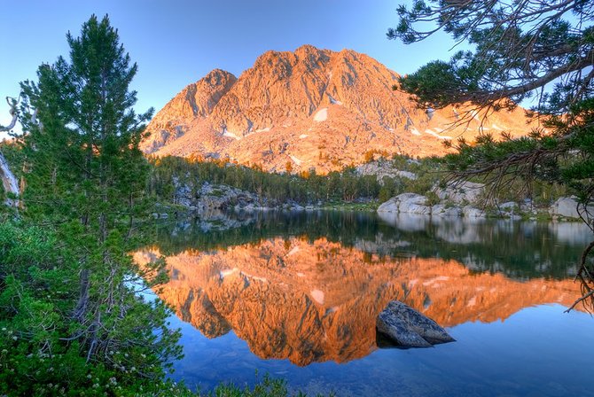 Wonder Lake, located in the Eastern Sierras just outside of Bishop, California.  A favorite backpacking destination that its at an elevation of 11,500 feet. This photo was taken just as the sun was rising it turned this peak a pink color for about 10 -15 minutes before it bleached out as the sun became stronger.