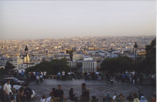 Sitting on the steps of the Sacre Coeur overlooking Paris in the late afternoon.