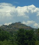A photo of Mt. Helix with an East County Thunderhead in the background.