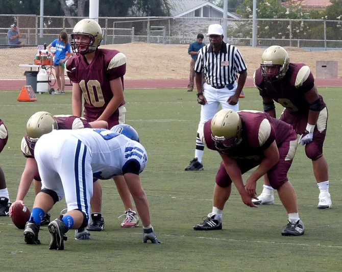 Bishop’s quarterback Michael Hinkley under center with running back Micah Seau in the backfield