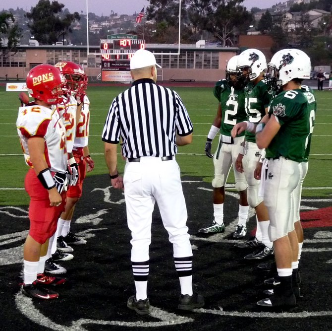 Team captains meet at midfield for the coin toss