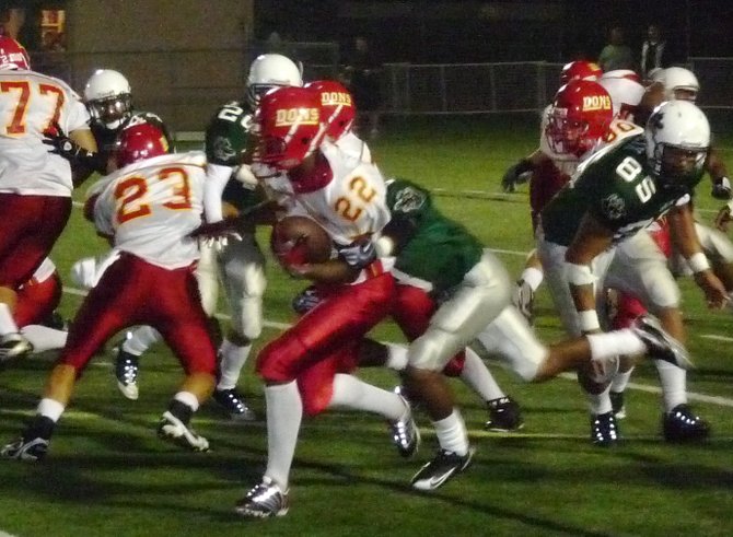 Cathedral Catholic running back Jonny Martin wrapped up by a Helix defender