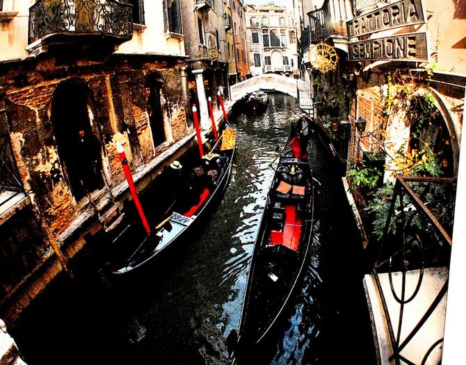 The gondolas pass each other with precision in Venice.