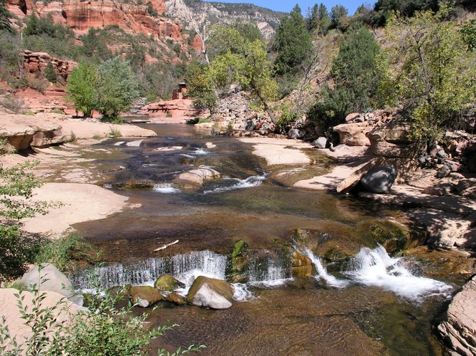 Oak Creek Canyon is a gem of red rocks and water that snakes down from north of Flagstaff to south of Sedona.  This picture is taken near Sliderock, a popular area about 12 miles north of Sedona.  
