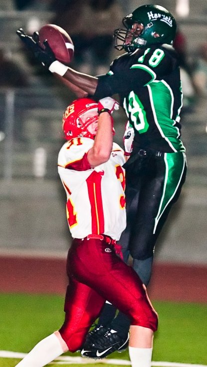 Lincoln receiver Dewayne Donald goes up to make the catch over a Cathedral Catholic defensive back.