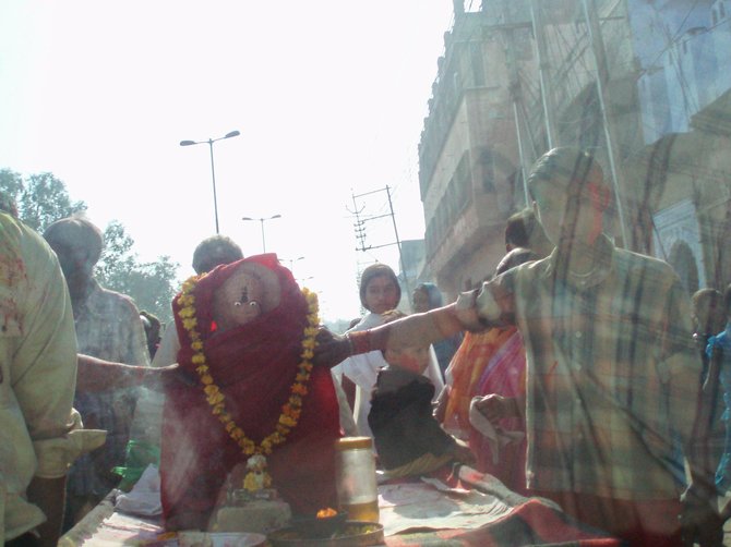 A Hindu festival in Varanasi, India. I took this from the back seat of my taxi which had paused due to traffic. The figure is the Hindu god, Hanuman.