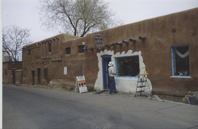 The oldest house in America getting a touch up. Santa Fe, New Mexico