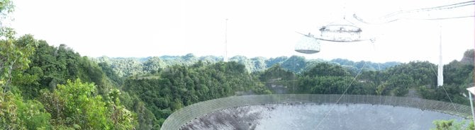 The Arecibo radio telescope in the mountions of Puerto Rico.  The movies "Contact" and "Goldeneye" were filmed here. 