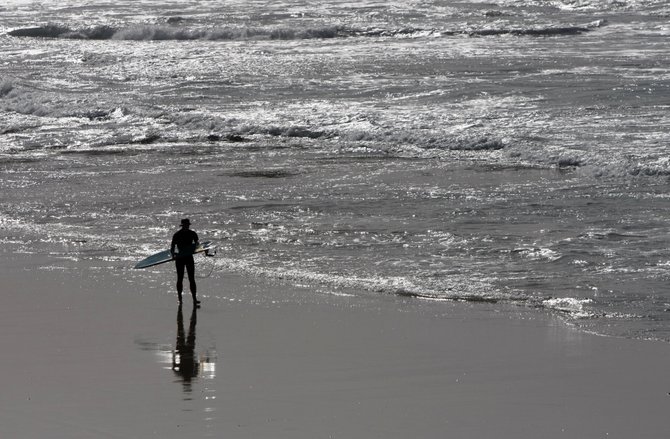 A lone surfer winds down the day.