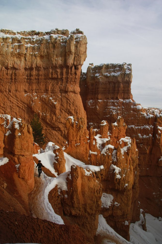 Lone hiker on the Wall Street trail in Bryce Canyon.  To avoid crowds, see this national park in the off-season.