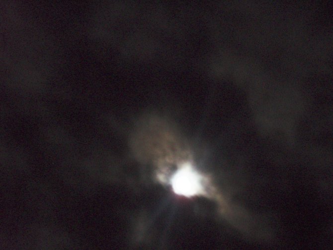 I took this picture of an unusual cloud/moon formation in Montezuma, Costa Rica. I see a sleeping Albert Einstein resting his chin on the moon. What do you see?