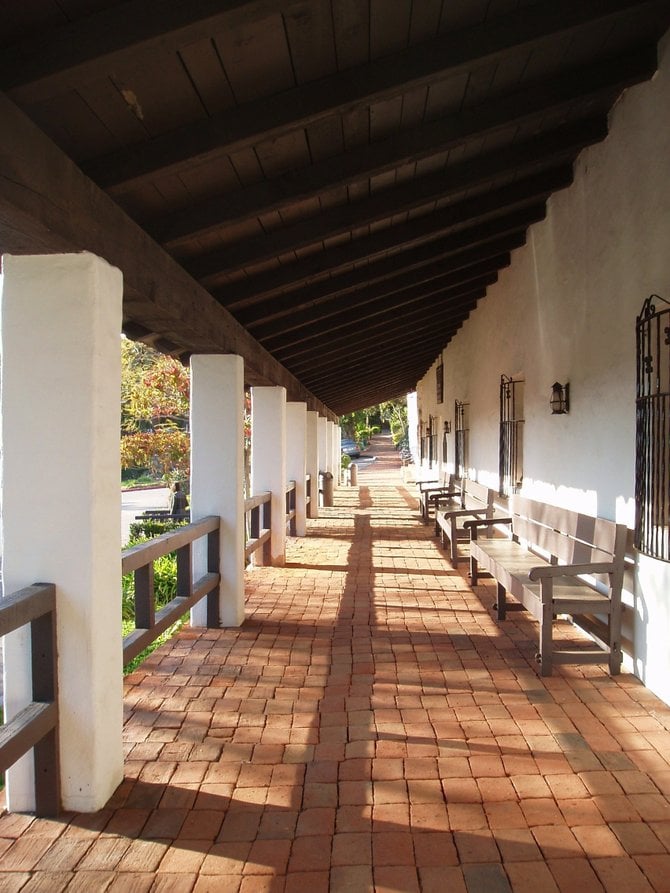 The covered portico at Mission Basilica San Diego de Alcala. Directly behind this walkway is an excavation site that dates back to 1769 when the original mission was built was on this site. The
current church, which is actually the fifth incarnation of the mission (due to expansions and a rebuild after an 1812 earthquake) was built in 1813. This portico was built in 1931 during a period of restoration. It is a re-creation of the original portico which had long been destroyed. 