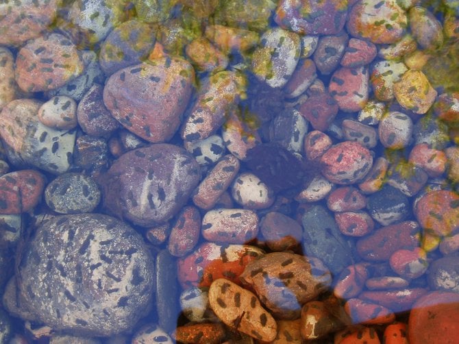 Reflections and algae on the rocks in the stream in the water feature at the Mission Valley Library. 