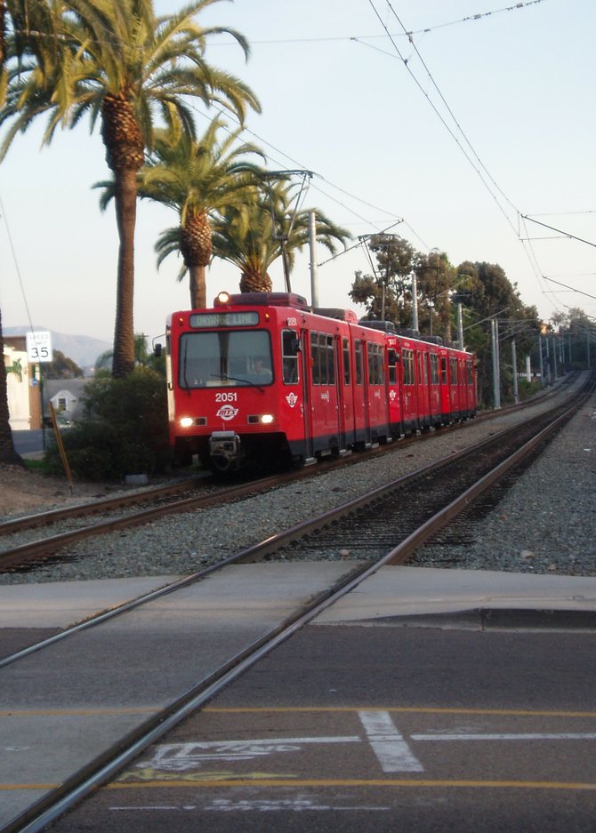Here's one of the San Diego trolleys whizzing toward the Pacific Southwest Railroad Museum's restored La Mesa Depot and train cars at the intersection of La Mesa Blvd and Spring Street. It's an interesting contrast to see the new electric trolley cars right next to the old 1800's era steam trains.   