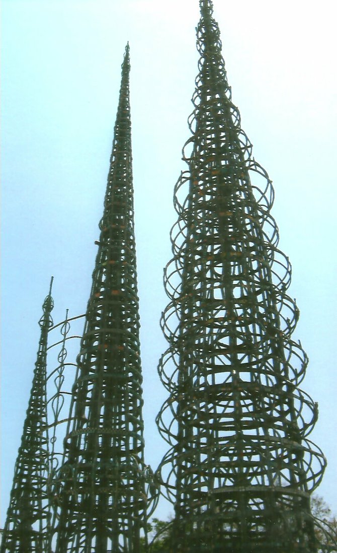 Simon Rodia arrived in the US from Italy with a desire to do something big. He doggedly  created his masterpiece, the Watts Towers over the course of 33 years from 1921 to 1954.  Spires of reinforced concrete, the towers are constructed of a steel core wrapped in wire mesh. They are covered with mortar, and inlaid with a variety of materials that Rodia collected, including tile, glass, shell, pottery, ceramics and rocks.  Rodia considered himself an explorer in the mold of Marco Polo and the entire project can be considered a metaphor for a ship. The walls that frame the towers are shaped like a ship. The towers themselves represent the sails of the ship. An effort to save the Towers by two local artists was successful after they were condemned to be
demolished in 1957. The Towers are again in a precarious situation due to budget cutbacks. 