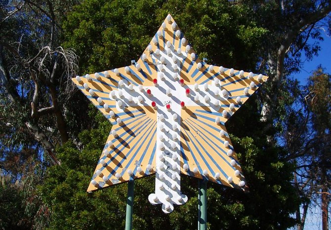  This is a Rosicrucian star cross, the emblem of the Rosicrucian Order of the Rose Cross, on the grounds of the Rosicrucian Fellowship in Oceanside. This particular emblem is made with what look to be circus marquee lights and was most likely constructed in the 1960's, when many changes and additions were made to the property.  