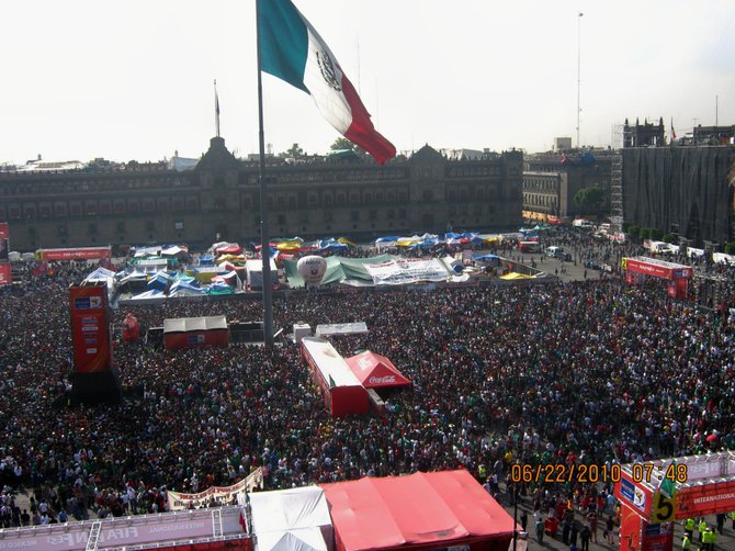  This huge crowd in Mexico City's zocalo is watching their beloved national soccer team play Uruguay in the World Cup. A huge screen broadcasts matches throughout the tournament. 

