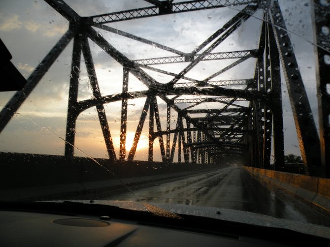 Crossing a bridge from Tennessee into Arkansas at sunset.
