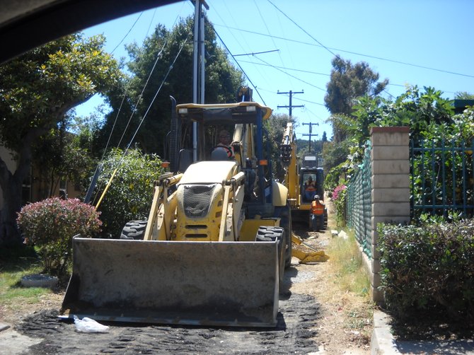 With the never-ending replacement of street sewer pipes in Point Loma area, workers enjoy a brief break.

