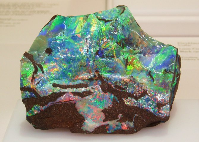 This is how opals appear before they have been removed from the surrounding rock. This chunk of rock is about the size of a large canteloupe and appears in the All That Glitters jewelry exhibition at the San Diego Natural History Museum.