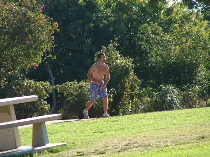And coming: Drunk flip-cup contestant finishes using the bushes at Kate Sessions Park, Saturday, Sep 25, 2010