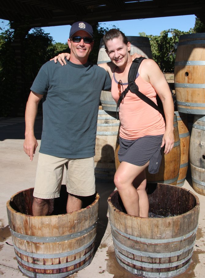 A couple stomps grapes at the beginning of fall harvest at
Wilson Creek Winery in Temecula