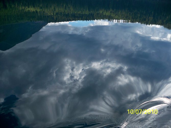 Glass top lake!  Sky reflection on Holland Lake surface (in Montana).  I took this while canoeing on the lake in route to Harper Water Fall.