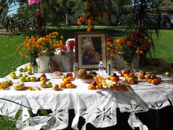 An alter honoring the late Pope John Paul II is on display at the Day of the Dead festival at the mission on Sunday, October 31, 2010.