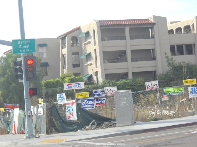 Visual pollution aka recent campaign signs litter a fence along Clairemont Drive.