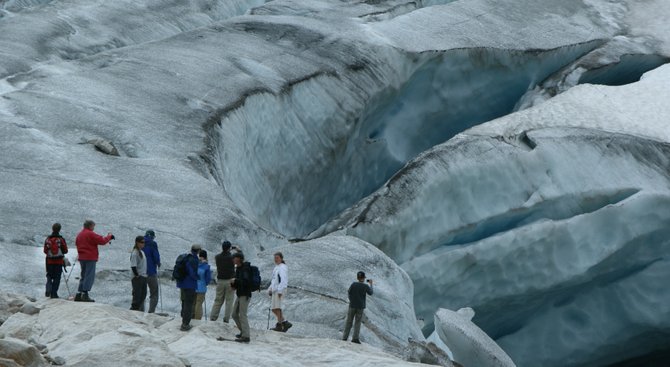 Visitors to the Canadian Rockies play on a glacier.
