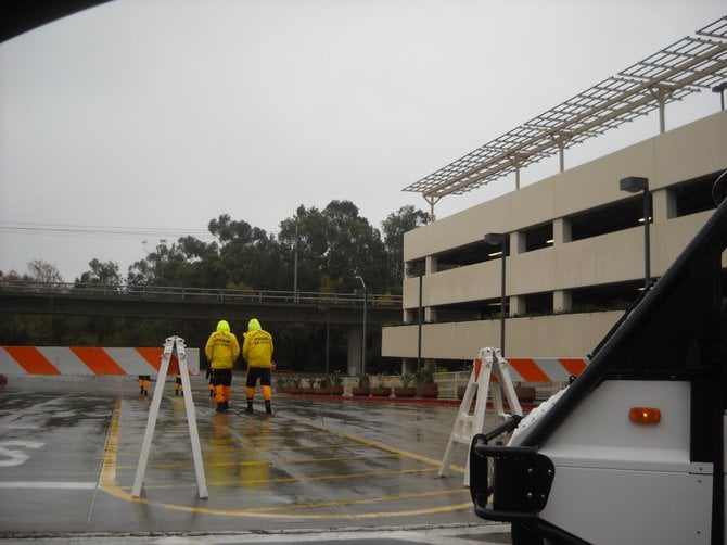 Lifeguards patrol Fashion Valley during rain deluge in late December.
