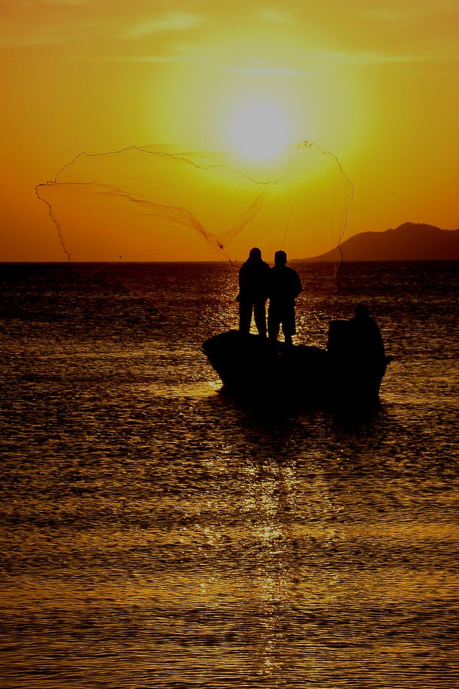 Baja fisherman near Loreto, catching their bait at sunset before heading out for a night of fishing.
