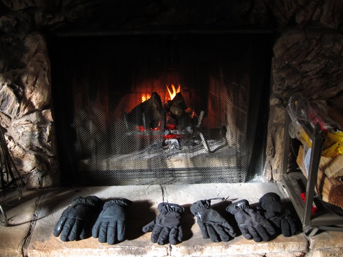 Gloves drying by the fire after a day of snowboarding in Big Bear.