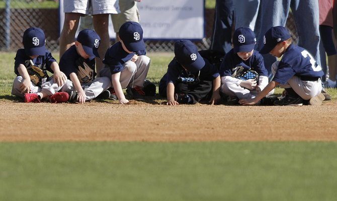 Opening day of Little League baseball.  Some kids are a little distracted from the ceremony.
