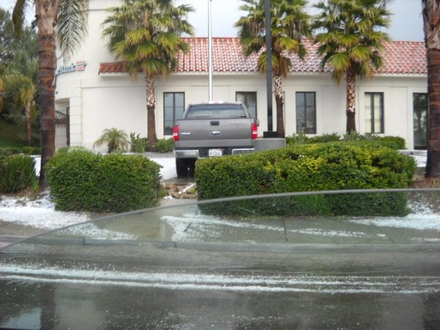 Snowy white lawn in Solana Beach during hailstorm.
