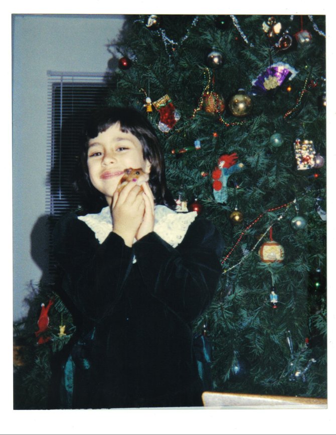 "MERRY CHRISTMAS!!!" My niece at a young age, holding her pet hamster in front of the unfinished tree.