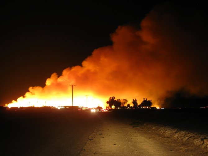 A major haystack fire located in the Imperial Valley. Someone had set fire to these haybales at Silsbee Road, West of El Centro, CA.  This fire is considered arson and security guard was beaten prior to being set.