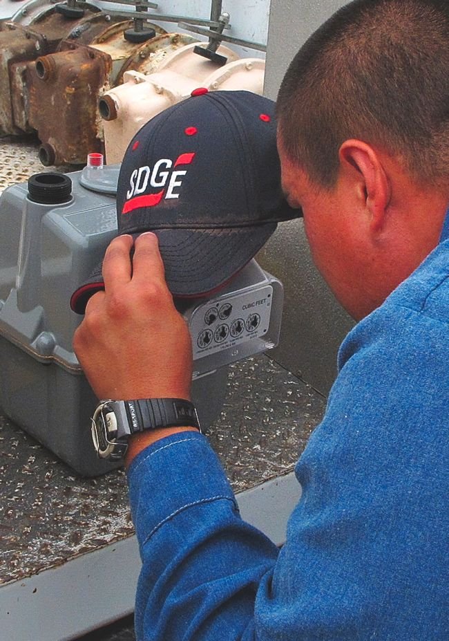 An SDG&E worker installs a gas meter with a smart-meter module.