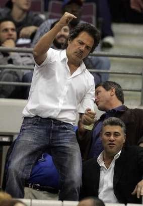 U-T owner Tom Gores dances "almost John Travolta-like" at a Detroit Pistons game. He recently bought the team.