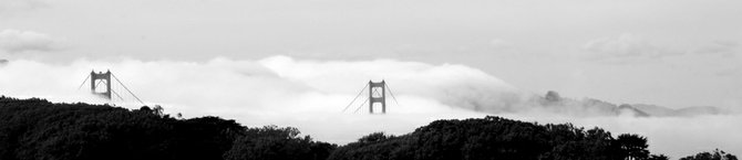 The fog rolling in over the Golden Gate Bridge.