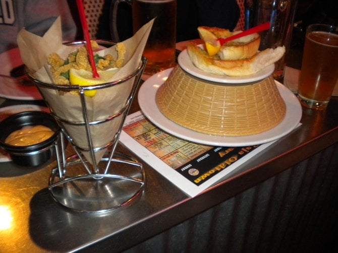 My $6 calamari in the cone holder; the $5 plate of mussels under the shell-discard basket.